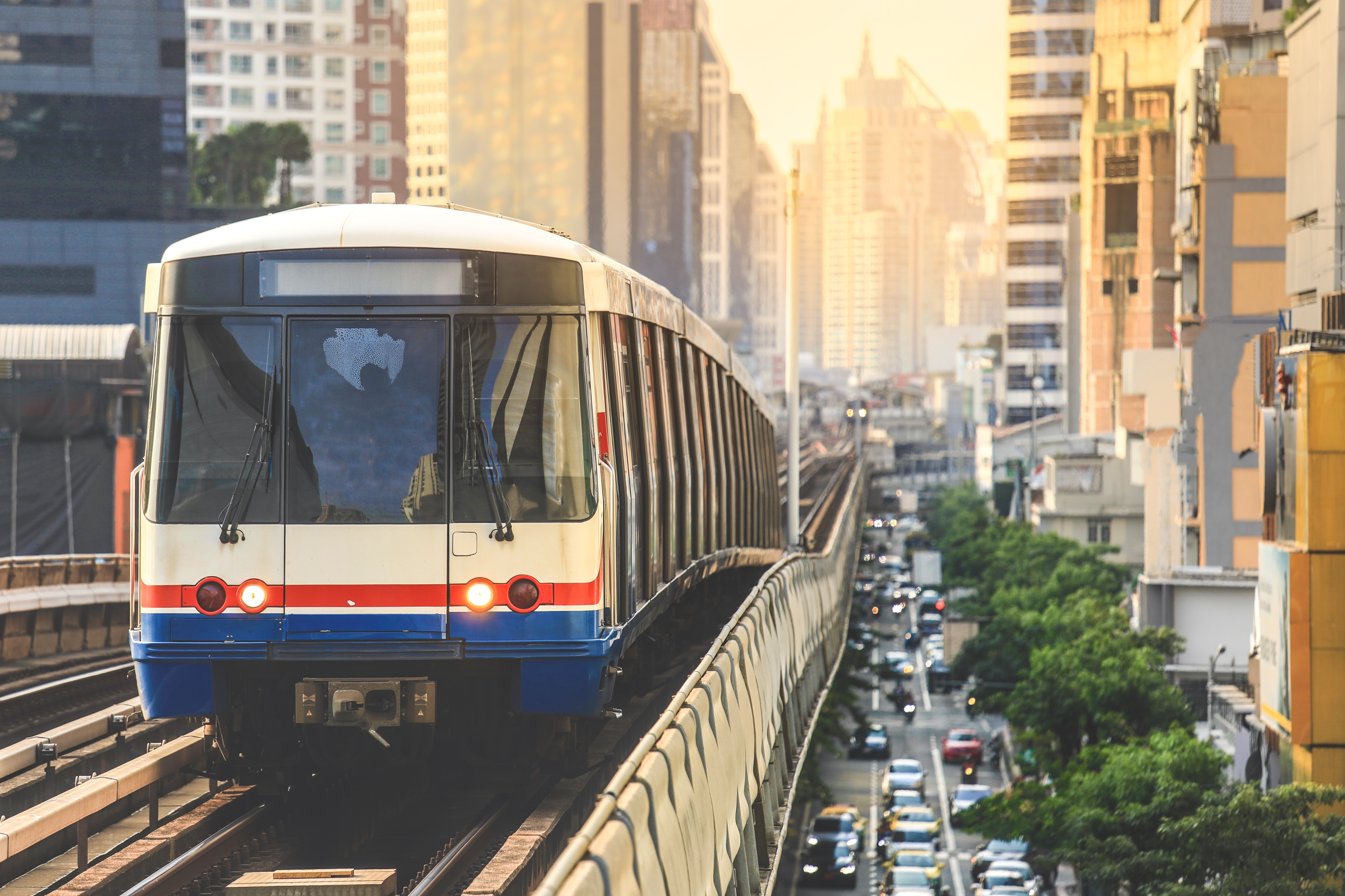 BTS Sky Train running in downtown Bangkok during morning commute