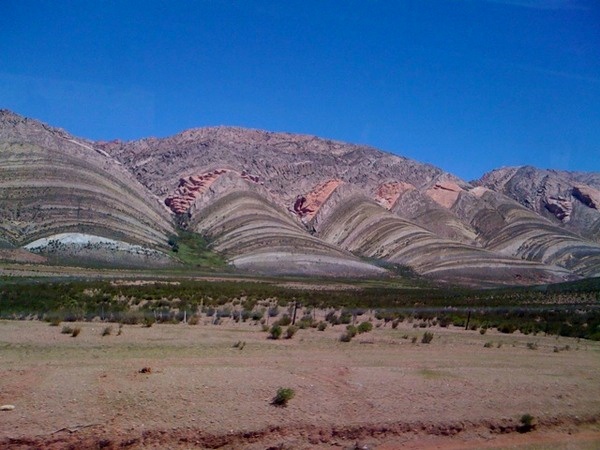 Passing by wonderful swirled sandstone hills in Argentina