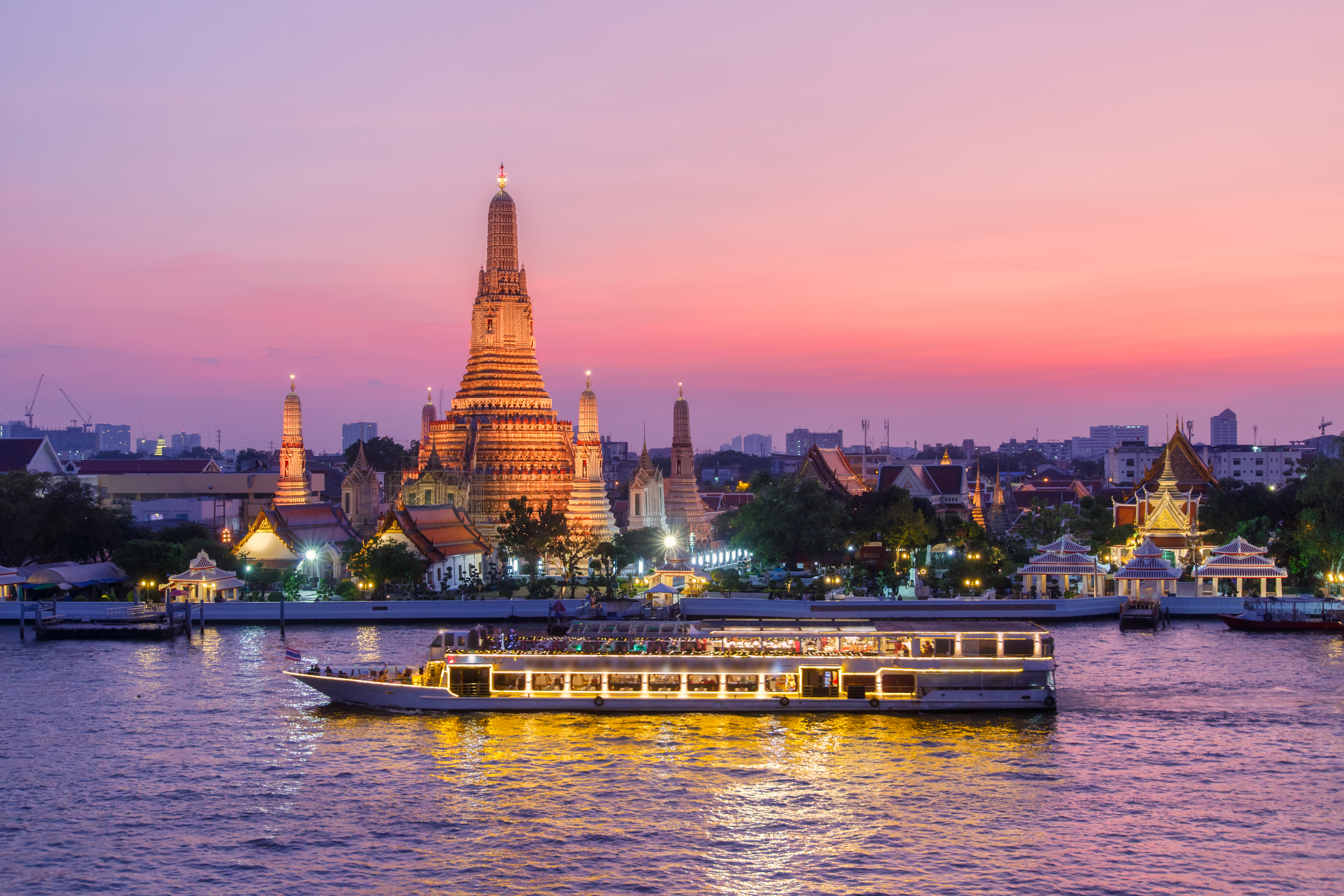 Wat Arun and cruise ship in night in Bangkok, Thailand