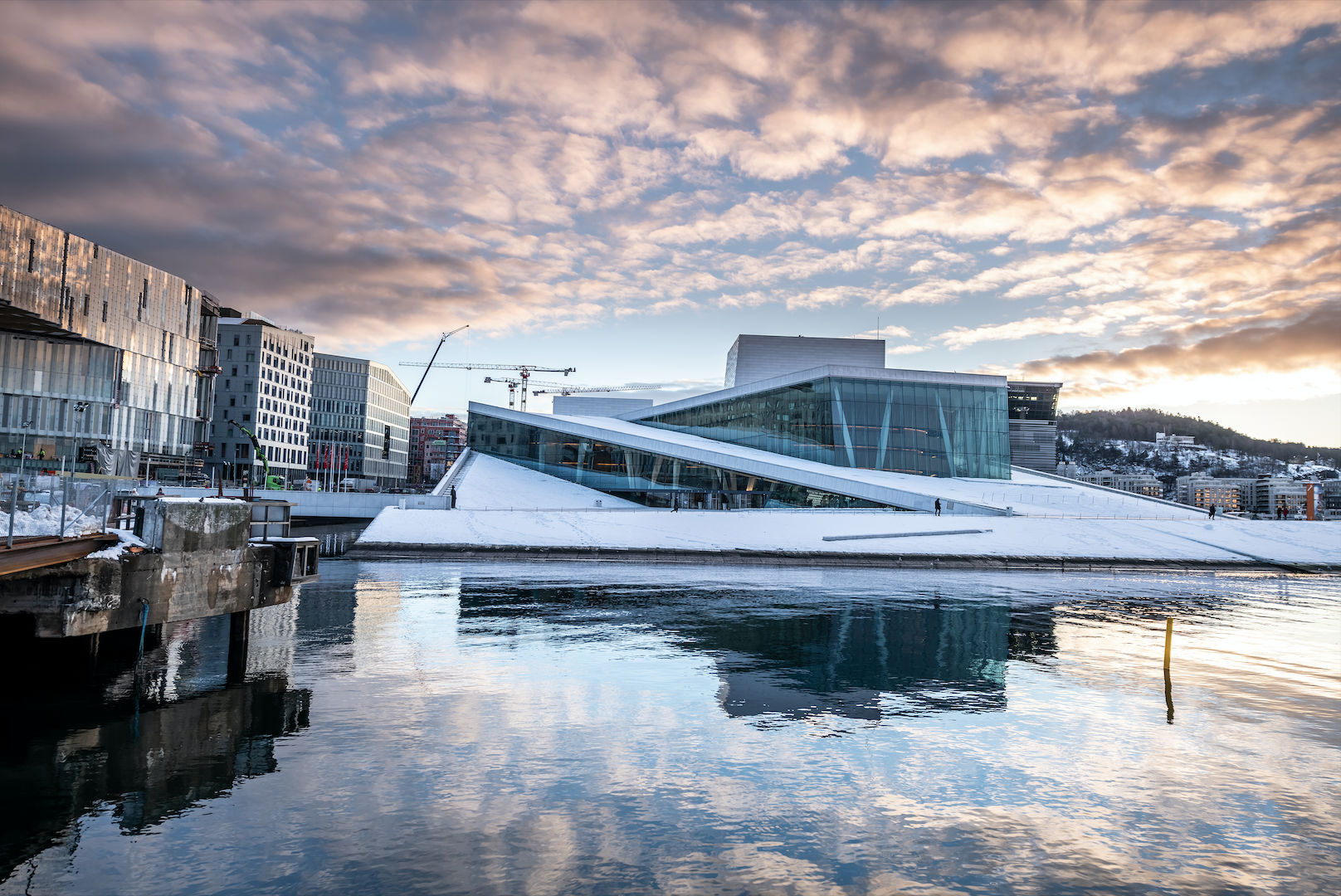 View of the Oslo Opera House with a cloudy sky.